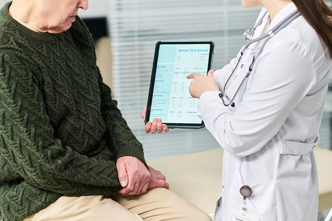 A physician reviewing blood test results with a patient